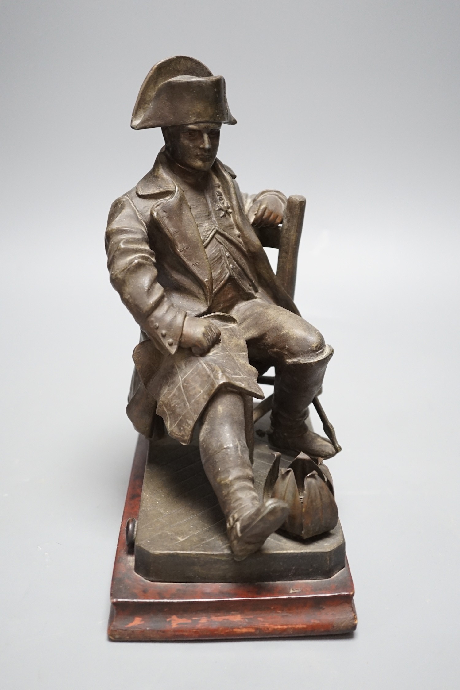 An early 20th century bronzed metal table lamp moulded as Napoleon seated, 26cm